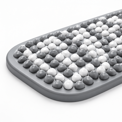 Close-up of rounded corner and gray border of bath mat